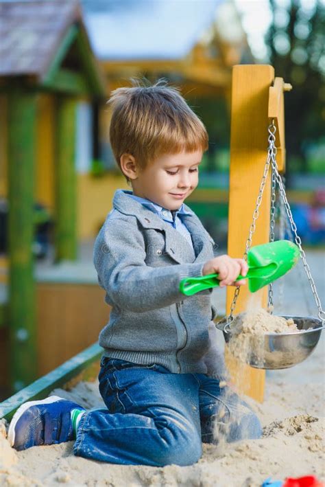 Happy Little Boy Playing In Sandbox At Playground Stock Photo Image