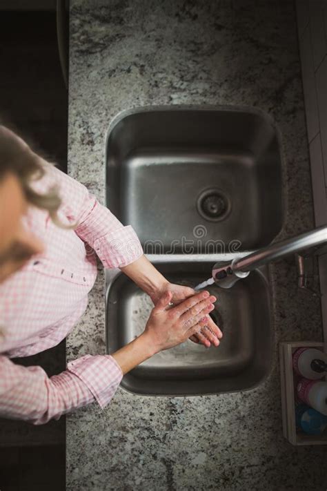 Young Woman Washing Her Hands At The Kitchen Sink Stock Photo Image