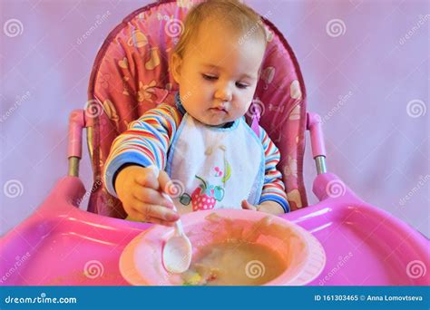 Baby Eating Porridge On A High Chair Stock Image Image Of Appetizing