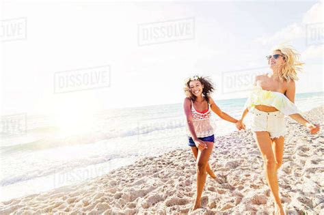 Female Friends On Beach Stock Photo Dissolve