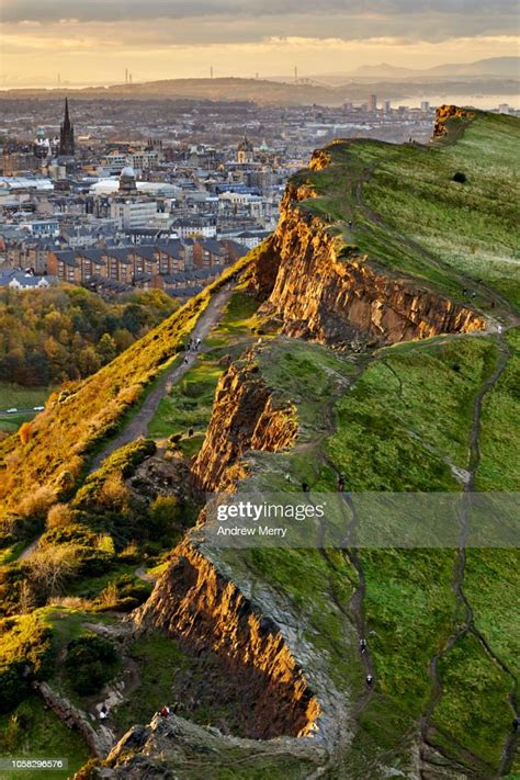 Rocky Cliffs Of Salisbury Crags In Holyrood Park With Edinburgh City