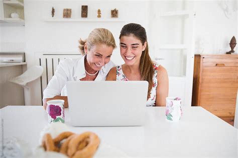 Happy Mother And Daughter Using Laptop Computer Together By Stocksy Contributor Michela