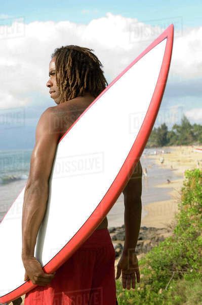 Man Holding Surfboard On Beach Maui Hawaii Stock Photo Dissolve