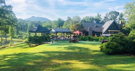 A Grassy Area With Picnic Tables And Gazebos