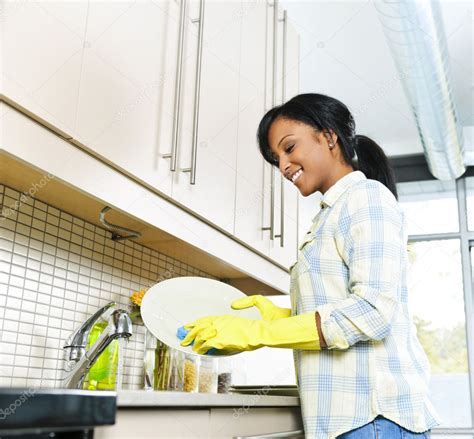 Young Woman Washing Dishes — Stock Photo © Elenathewise 6650813