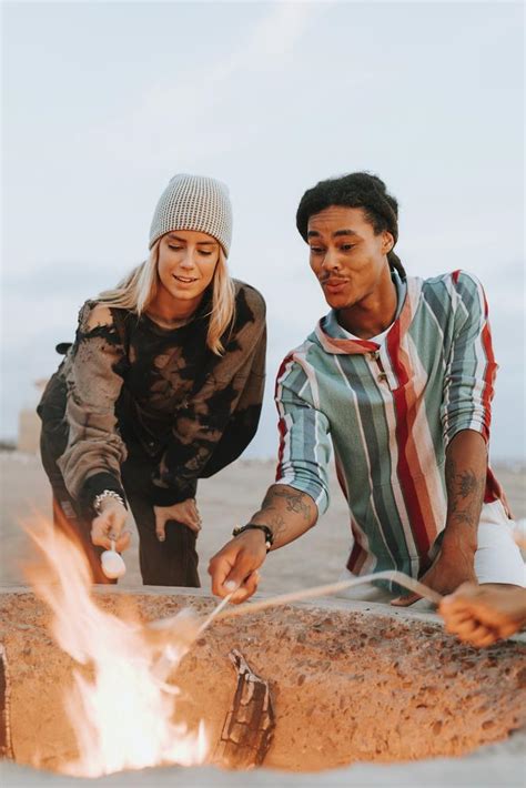 Couple Roasting Marshmallows Over A Bonfire Premium Photo Rawpixel