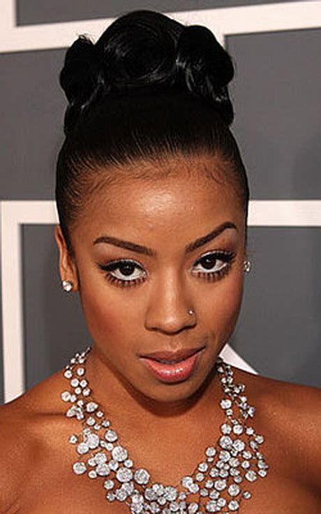 She has lovely gray and black curls and the locks are designed as an updo. Black bun hairstyles