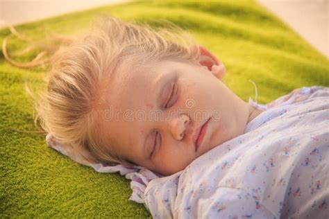 Blond Kid Sleeps In Baby Stroller With Had On Hand Hold Hot Sunny