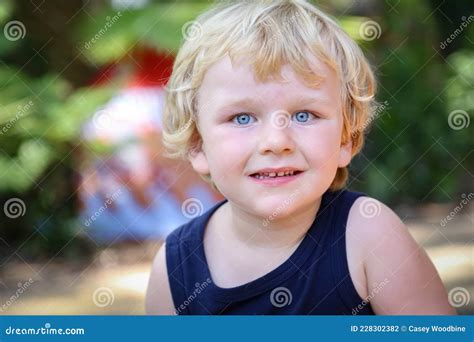 Portrait Image Of Beautiful Little Blonde Hair Blue Eyed Boy In Vibrant