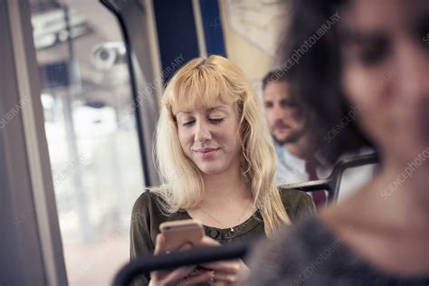 A Blond Woman On A Bus Using A Cell Phone Stock Image F0128532