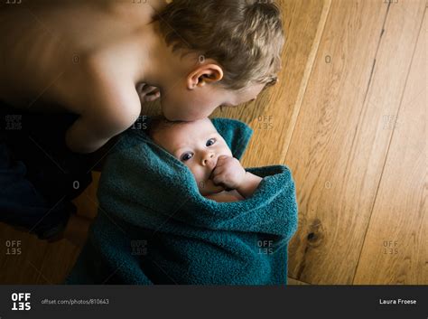 Boy Kissing His Baby Brother After Bath Stock Photo Offset