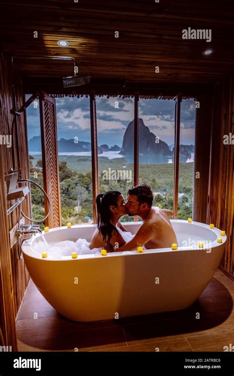 Couple On Honeymoon Vacation Bath Tub With A Look Over The Bay Of