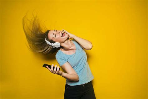 Image Of Woman Listening To Music With Headphones On Yellow