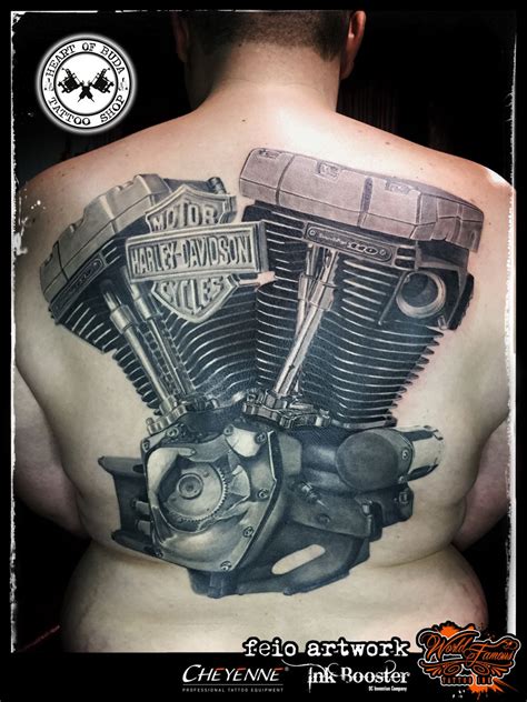 A Man With A Motorcycle Engine Tattoo On His Back