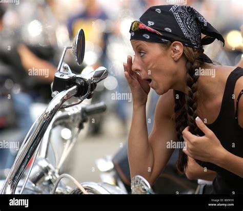 Biker Girl Chick Checks Her Make Up In Mirror Of Harley Davison Bike In