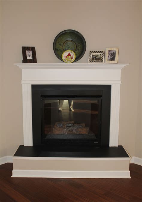A Corner Gas Fireplace With A Raised Hearth Slate Surround And Wood