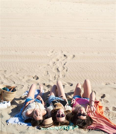 Three Girls On Beach Blanket By Stocksy Contributor Guille Faingold