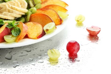 Premium Photo Assortment Of Sliced Fruits On Plate With Drops