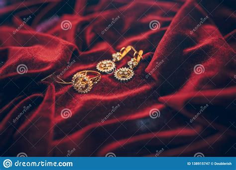 Golden Jewelry With Gem On The Red Velvet Background Stock Image
