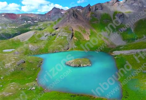 Turquoise Blue Mountain Lake In Green Valley Aerial Approaching View