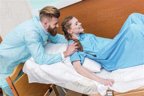 Pregnant Woman Giving Birth In Hospital While Man Hugging Her Stock Photo Dissolve