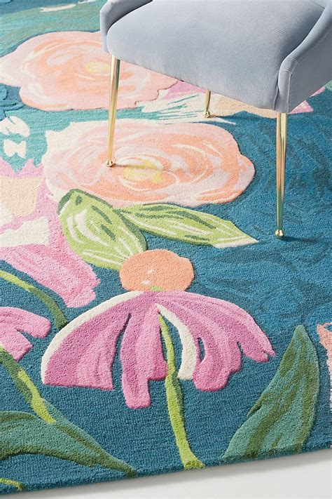 A Blue Rug With Pink Flowers On It