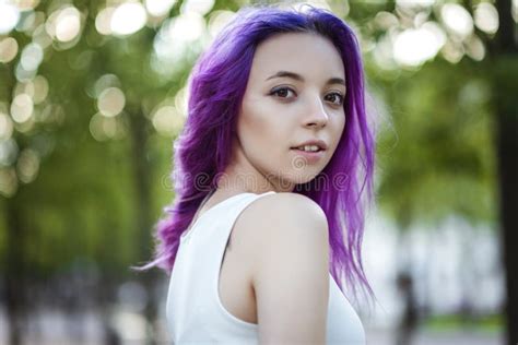 Beautiful Young Violet Hairy Girl Walking At Sunset In A City Park St