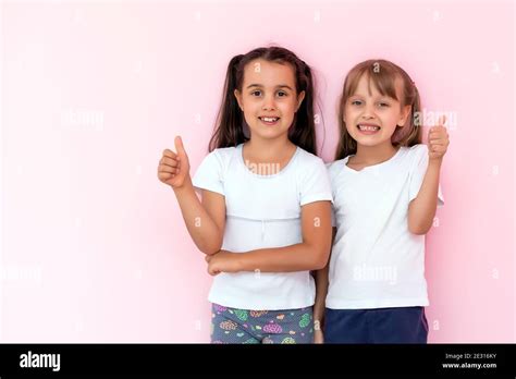 Children Showing Like Two Adorable Happy Little Girls Gesturing Thumbs