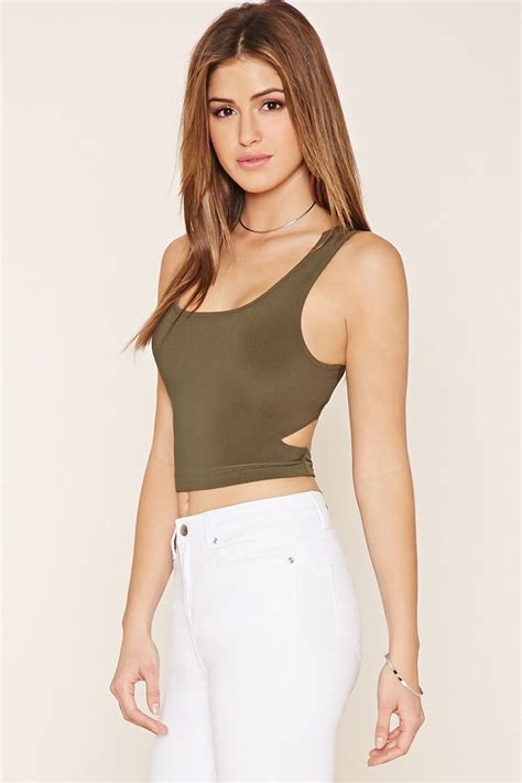 a sleeveless crop top featuring cutouts at the waist self tie straps in back and a scoop