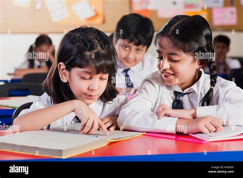 Indian School Kids Students Reading Book Studying In Classroom Stock