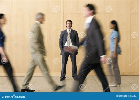 Confident Businessman With Team Walking Past Him Stock Photo Image Of