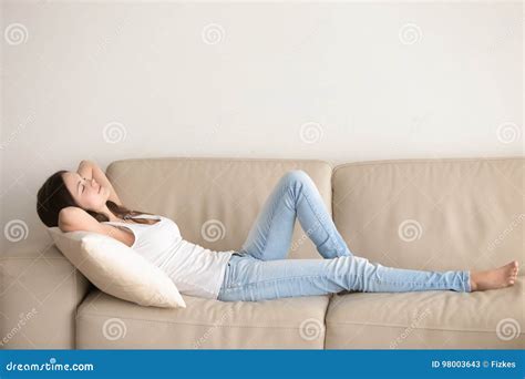 Young Woman Lying On Couch Relaxing With Hands Behind Head Stock Image Image Of Lazy