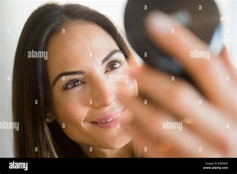 Caucasian Woman Admiring Herself In Compact Mirror Stock Photo Alamy