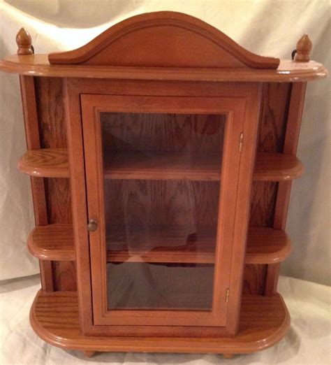 Beaming with handcrafted pride, this curio cabinet features glass shelves, beveled glass doors, and two halogen dome lights to proudly display and protects your most prized items. Vintage Large Wood Display Case Table / Wall Hang Glass ...