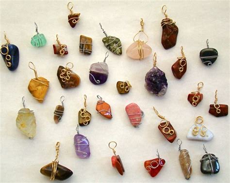 A Collection Of Different Colored Stone And Metal Items On A White Surface With Gold Earwires