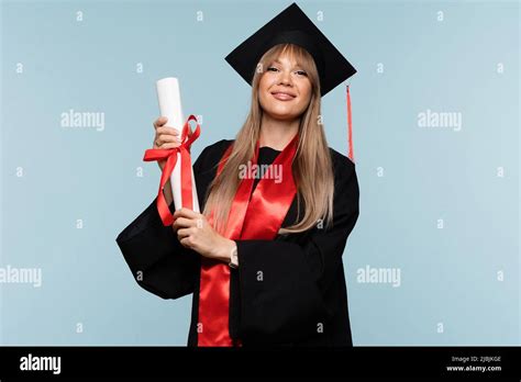 Girl Graduate In Graduation Hat With Diploma On Light Blue Background