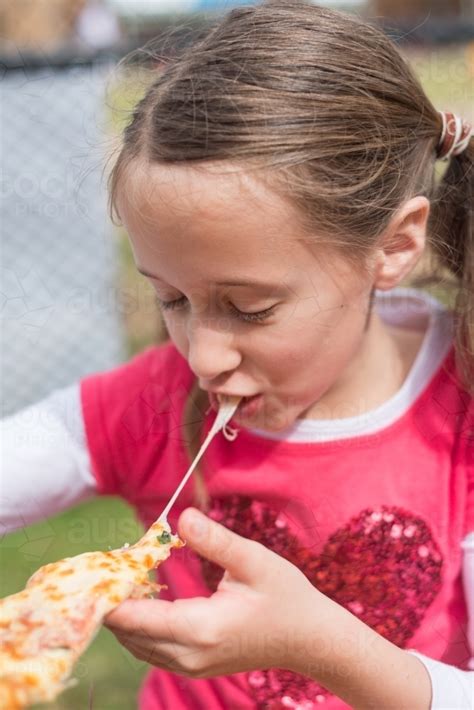 Image Of Tween Girl Eating Pizza Austockphoto