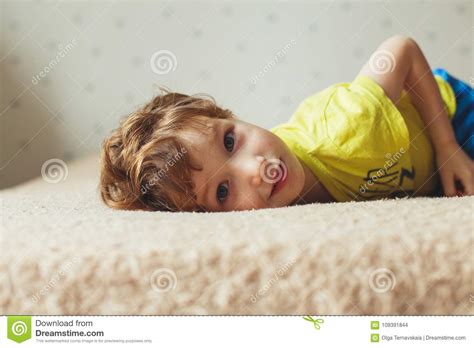 Beautiful Little Boy Lying On Bed And Looking Curly Cute Toddler Stock