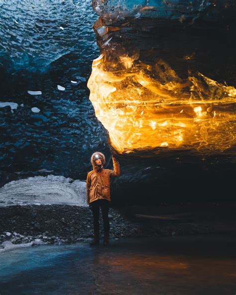 Photographer Captures Incredible Amber Glow Inside Icelands Ice Caves