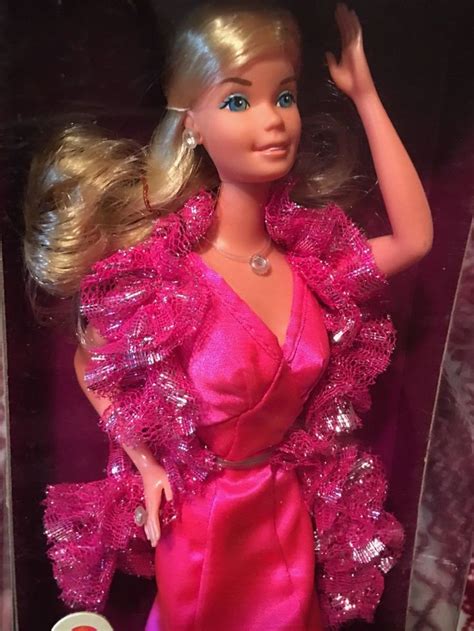 The Barbie Doll Is Wearing A Pink Dress