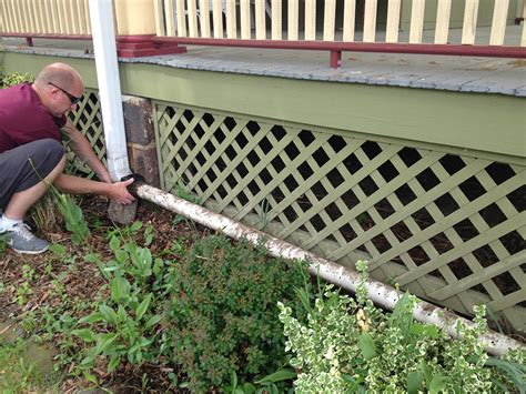 A downspout serves as a gutter drain. DIY Rain Gutter Watering System: Turn your gutter into a ...