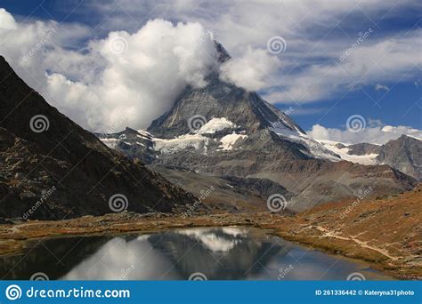 A Mountain Matterhorn View Partially Covered By Clouds On A Mountain