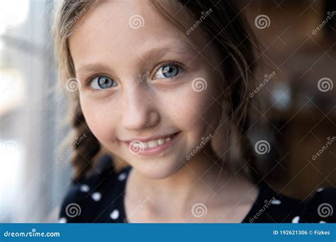 Close Up Portrait Of Happy Little Caucasian Blue Eyed Girl Stock Photo
