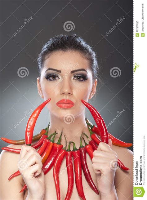 Beautiful Young Woman Portrait With Red Hot And Spicy Peppers Fashion