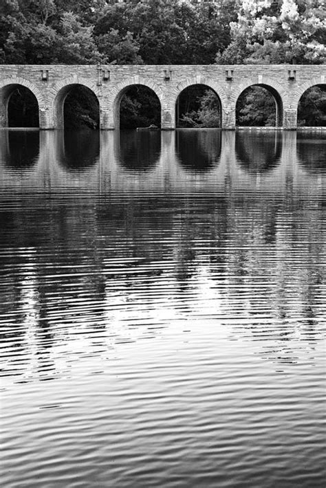 Arches Of An Old Stone Bridge Reflecting In Quiet Water Bandw Photograph
