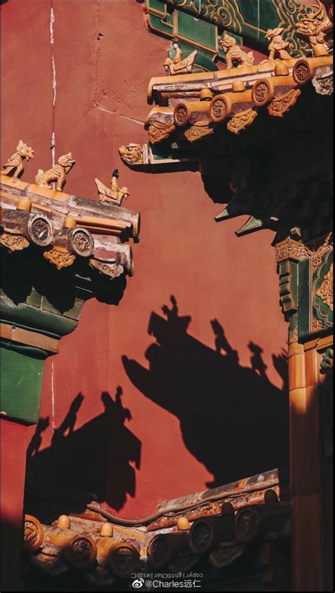 Shadows Cast On The Side Of A Building With Elaborate Carvings And Roof