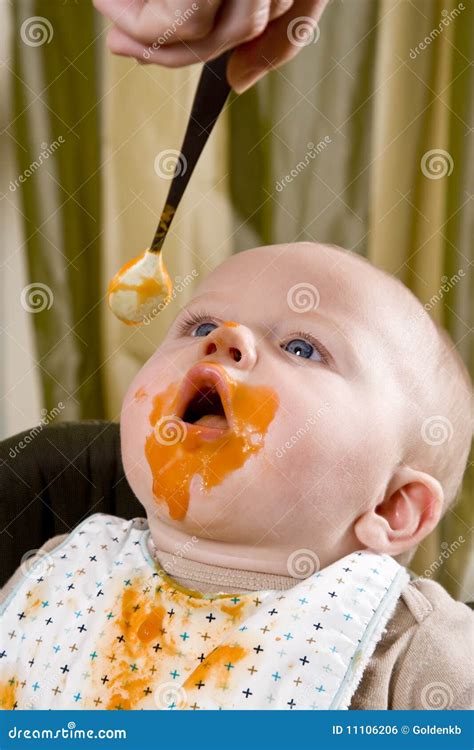 Messy Hungry Baby Eating Solid Food From Spoon Stock Photo Image Of