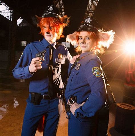 Two People Dressed As Police Officers Posing For A Photo
