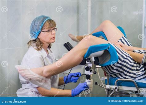 Senior Female Positively Gynecologist Examining A Patient At Clinic