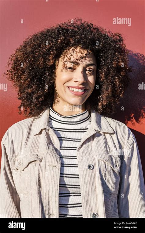 Vertical Portrait Of A Beautiful Smiling Latina Woman With Curly Afro
